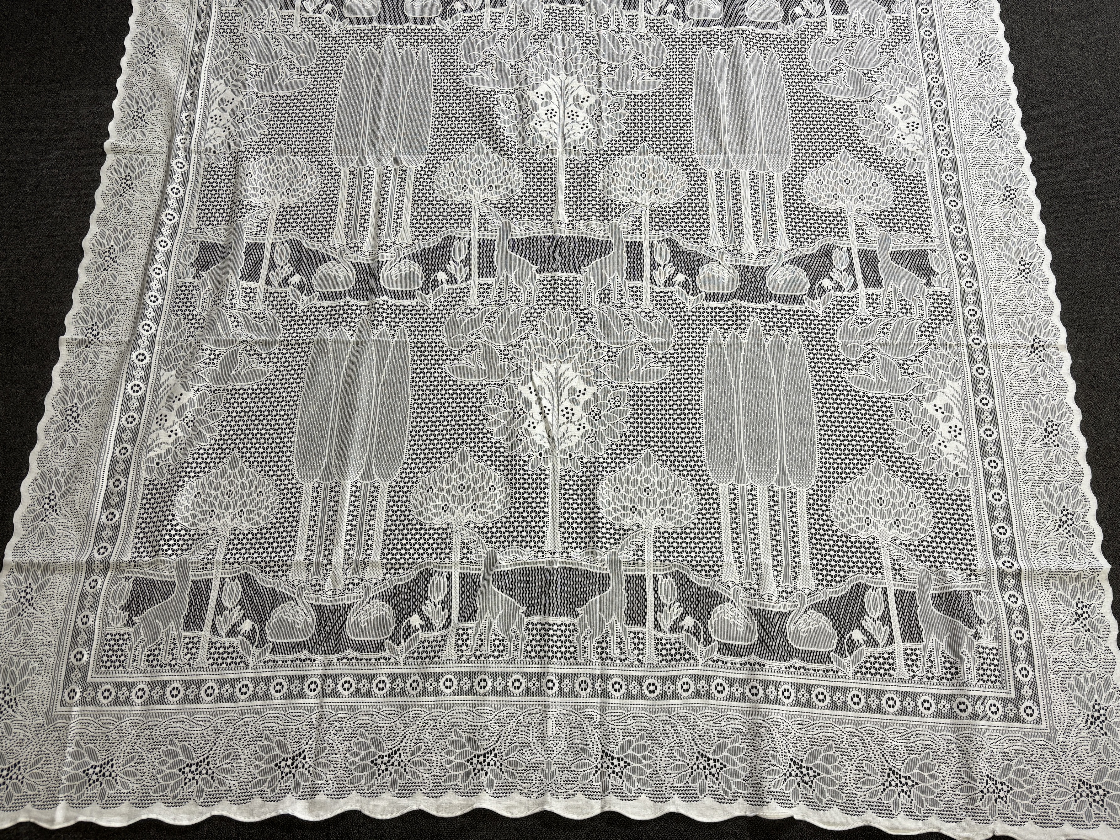 A set of three C.F.A. Voysey design “The Stag”, machine made, cotton lace curtains manufactured by Rose’s Mill Ltd, Ayrshire, unused, 180cm x 240cm